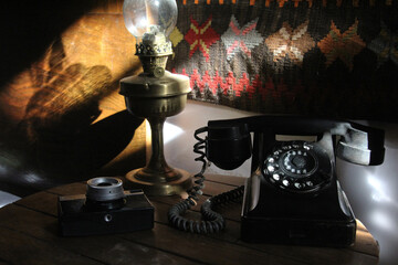 old fashioned phone with lamp and vintage camera