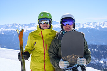 Fototapeta na wymiar Skiing and Snowboarding Buddies on Alpine Slope