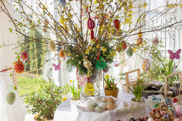 Easter eggs on willow branches in a vase.