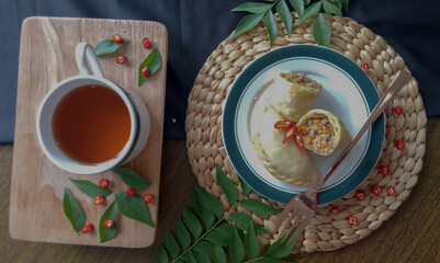 Empanada or Panada, Indonesian traditional snack from Manado, North Sulawesi. Enriched with filled with shredded smoke skipjack tuna fish at the inside. Selective focus.

