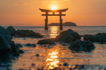 The setting sun shines on the sea, with an island in front of it and a small torii gate standing tall on top of rocks