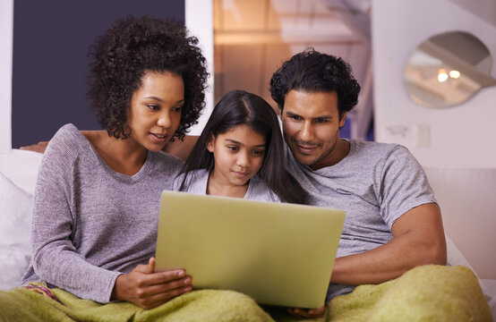 Family, girl and sofa with laptop to watch movie on online website for educational programs or child development. Parents, home and bonding with streaming cartoon in living room, learning and support