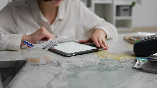 Operator, competent manager works with an electronic tablet. tablet screen, in slow motion, an airline employee works in an airline company, helps with paperwork, government agency