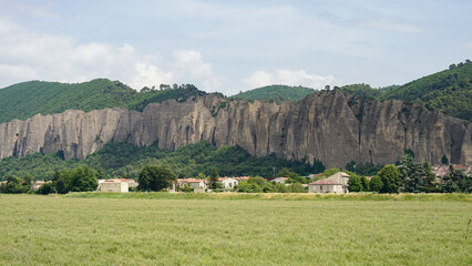 Penitents des Mees, interesting rock cliffs above village Mees, tourist landmark in France - obrazy, fototapety, plakaty