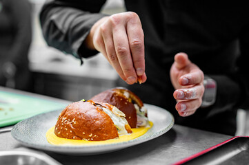 Chef garnishing a gourmet dish, showcasing culinary artistry and precision. Perfect for themes of food, cooking, and fine dining