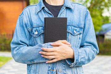 holding a book pressed to her chest