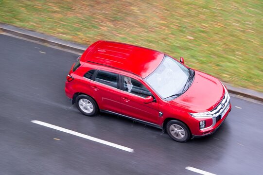 Mitsubishi ASX crossover car after third facelift in motion blur effect in rain