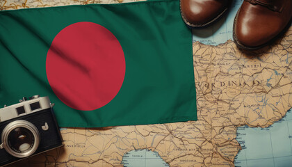 Bangladesh flag on the map surrounded by camera, shoes. Travel and tourism concept