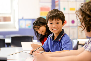 Boy student smiling in the classroom at a public school