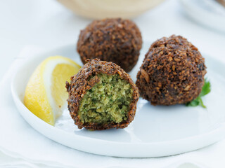 Falafel on white plate with lemon