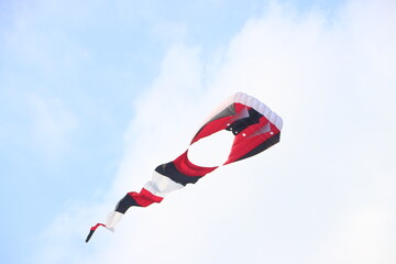 Colorful kites flying in the clear blue sky in summer at Mekong Delta Vietnam. Happy childhood moments.