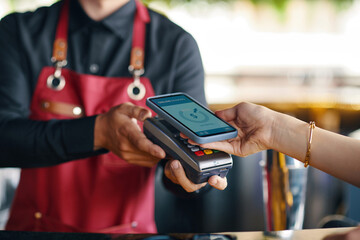 Woman using mobile payment app for order in restaurant - 765647693