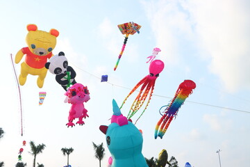 Colorful kites flying in the clear blue sky in summer in Mekong Delta Vienam.