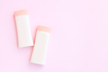 Cosmetic bottle containers isolated on pink background, Beauty products