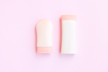 Cosmetic bottle containers isolated on pink background, Beauty products