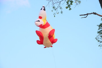 Colorful balloon kites flying in the blue sky in sunny summer day at Can Tho city, Vietnam.