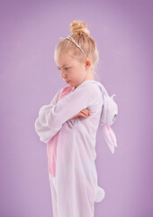 Girl, bunny and costume with attitude, studio and arms crossed for easter. Child, plush and youth with pastel, rabbit and grumpy for holiday with childhood dress up isolated on purple background