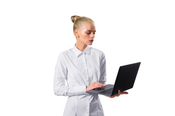 A professional young woman in a white shirt focused on working with a laptop, isolated on a white background, portraying a modern businesswoman - 765677019