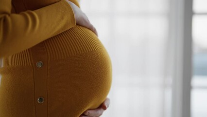 Woman stroking pregnant belly at home. Close up pregnant tummy of future mother enjoying pregnancy at home. Expecting waiting baby, family planning, healthy pregnancy, giving new life concept.