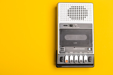 Vintage Portable Cassette Recorder on Yellow Background