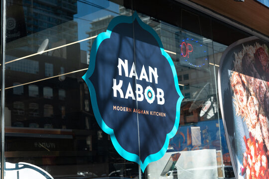 exterior decal sign of NAAN KABOB, an Afghan restaurant, located at 240 Queen Street West in Toronto, Canada