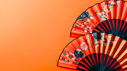 Traditional japanese fans on orange background
