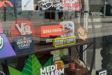 Fototapeta premium cannabis shop window display with brand logos on Queen Street West in Toronto, Canada