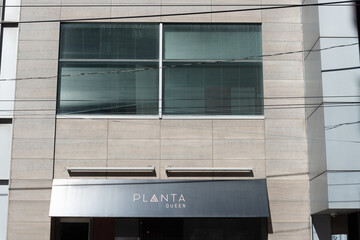 Fototapeta premium exterior building facade and sign of PLANTA, a vegan restaurant, located at 180 Queen Street West in Toronto, Canada