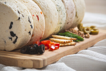 Several varieties of homemade cheese with different fillings from paprika, herbs, olives, walnuts...