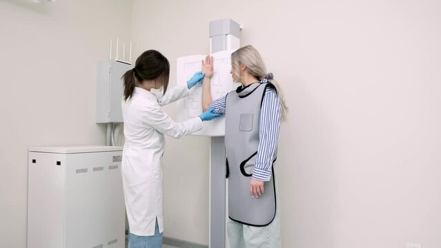 In a modern medical clinic, a young patient gets an x-ray of her arm after an injury. The concept of modern medical technologies, healthcare and treatment.
