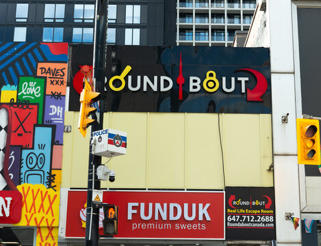 exterior facade and sign of Roundabout Canada Escape Room and Funduk, a confectionery, located at 330 Yonge Street in Toronto