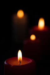 Burning candles on a black background