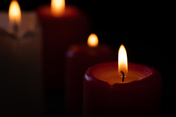 Burning candles on a black background