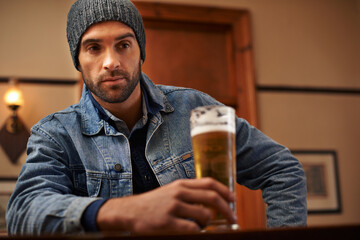 Beer, pub and male person thinking with alcohol, drinks and restaurant for entertainment. Pensive,...