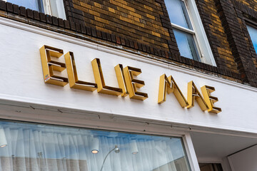 Fototapeta premium exterior building facade and open channel lettering sign of Ellie Mae Studios, a clothing store, located at 1096 Yonge Street in Toronto, Canada