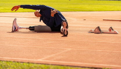 Asian para-athlete runner prosthetic leg on the track training alone outside on a stadium track Paralympic running concept.