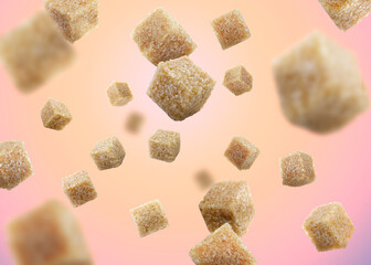 Brown cane sugar cubes falling on color gradient background