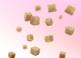 Brown cane sugar cubes falling on color gradient background