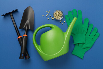 Green gardening tools on color background, top view © Liami