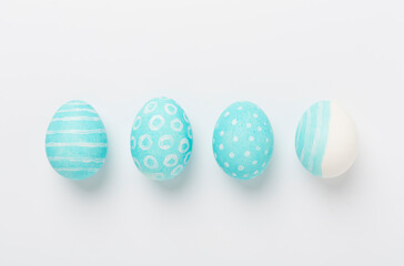 Blue easter eggs on white background, top view