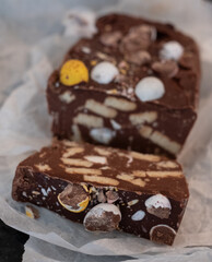 Close up of hand made Rocky Road chocolate dessert, with crushed mini Easter eggs digestive biscuits and marshmallows, for Easter celebrations. 