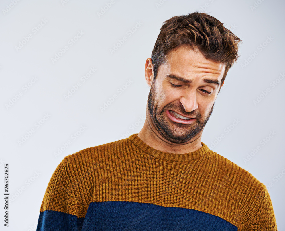 Poster man, frown and facial expression in studio for disgust and regret for attitude, emotion and mood. ma