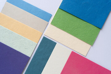 textured card in various colors arranged in staggered form on blank paper