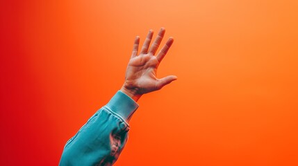 Vibrant Goodbye - A Close-Up of a Person’s Hand Waving Farewell Against a Warm, Orange Background - obrazy, fototapety, plakaty