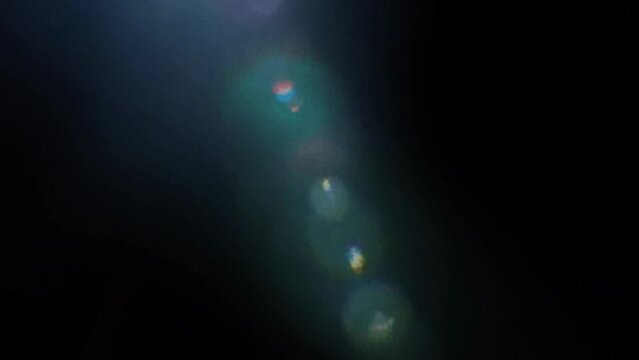 Sunlight bokeh deep forest lights comes in from sky flyer overly video effect Black background screen overlay effect 4k video sun beam under water overly flayer light from top at night video abstract