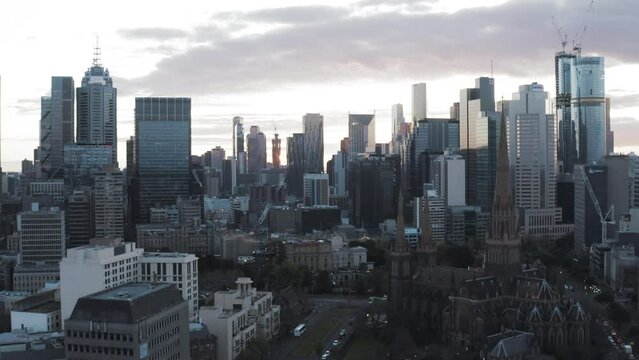 Aerial Panning Shot Of Roman Catholic Archdiocese Against Modern Towers In Downtown District Of City - Melbourne, Australia