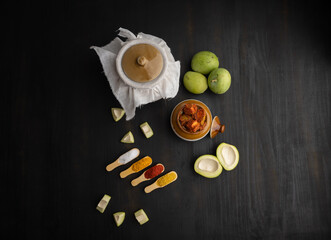 Homemade Mango Pickle or aam ka achar Kairi Loncha stored or preserved in China clay pot with...