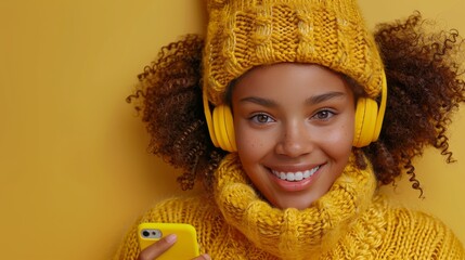 A woman wearing a yellow hat and a yellow sweater is smiling