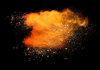 Abstract powder splatted background. orange powder explosion on black background. Colored cloud....