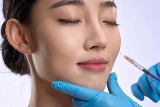Young women undergoing facial injections in medical beauty plastic surgery